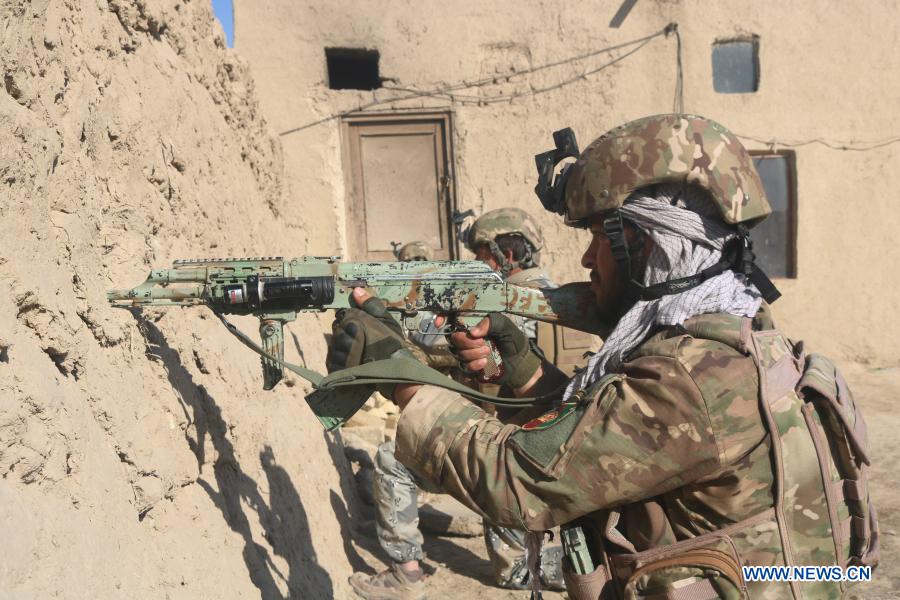 Afghan security force members take part in a cleanup operation in