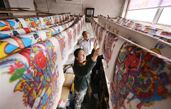 Workers make wood-block paintings in China's Shandong to supply festival market