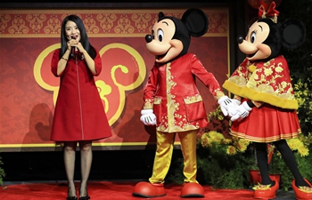 Feature: Renowned fashion designer brings touch of Chinese New Year festivity to Disney icon